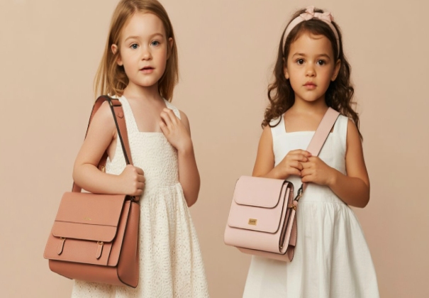 Baby girls wearing clothing accessories like clutches